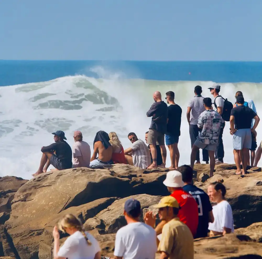 Candid moment of surfers relaxing on the beach in Tamraght Morocco after surfing