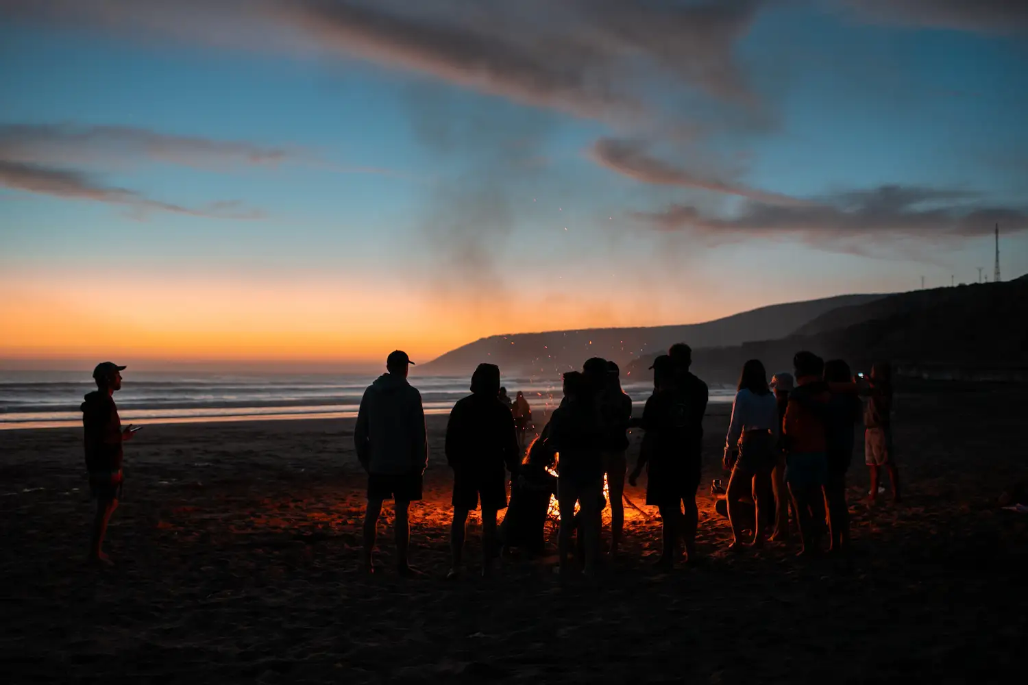 Friends enjoying the ocean view after surfing