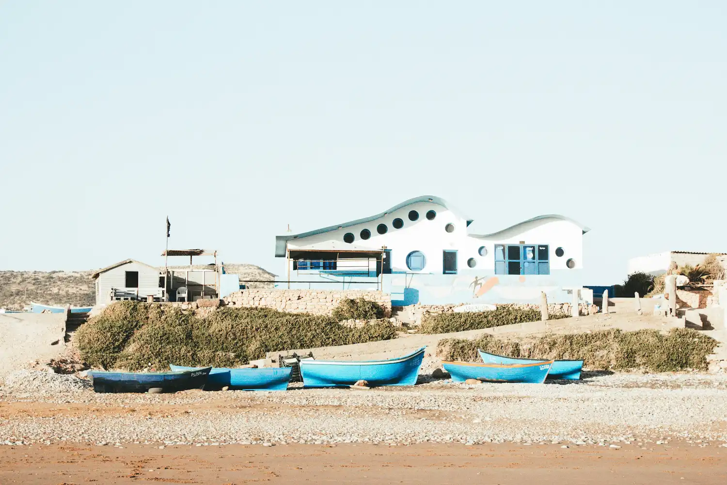 Coastal houses and small fishing boats in Tamraght Morocco along the Atlantic shoreline